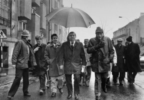 Delegacja „Solidarności” w drodze do Pałacu Namiestnikowskiego w Warszawie na rozpoczęcie obrad Okrągłego Stołu. Na zdjęciu Lech Wałęsa (pod parasolem), Tadeusz Mazowiecki (pierwszy z prawej), Piotr Nowina-Konopka (drugi z lewej), 6 luty 1989. Fot. Anna P